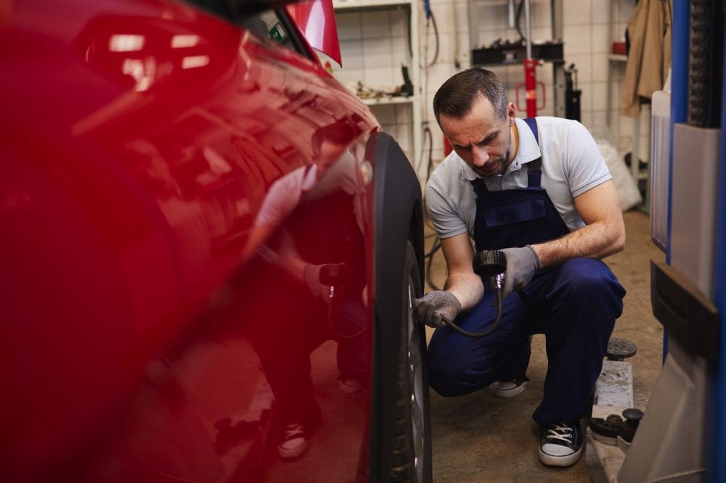 mechanic-checking-car-tires